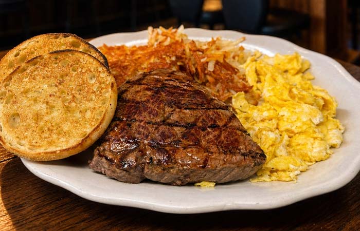Enjoy a Minnesota classic: grilled steak, eggs, hash browns, and muffin at Liberty’s in Downtown.