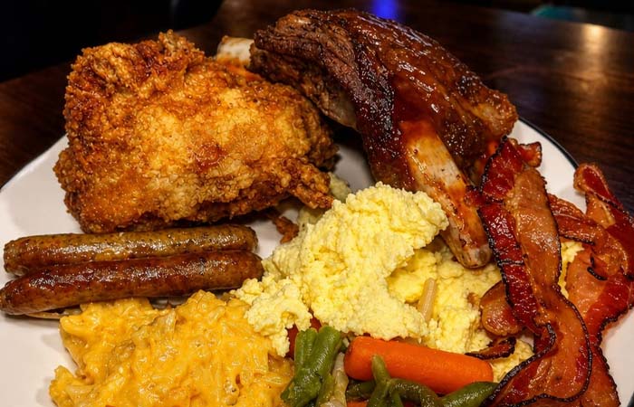 A hearty plate at our downtown Minnesota restaurant: fried chicken, ribs, eggs, and more delights.