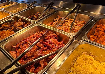 Metal trays of bacon, eggs, and more await at this downtown Red Wing MN bar’s breakfast buffet.
