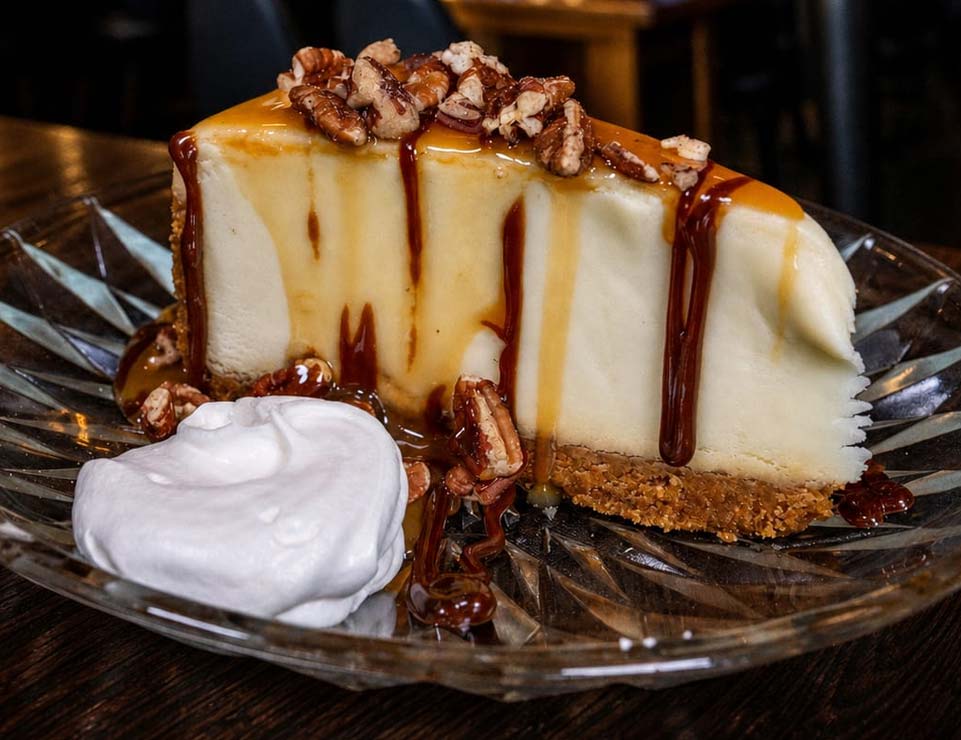 Savor this slice at Liberty’s Restaurant in Red Wing, MN—caramel cheesecake with pecans awaits!.
