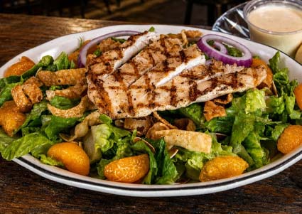 Grilled chicken salad with mandarins, onions, and crispy strips at our Downtown Restaurant.