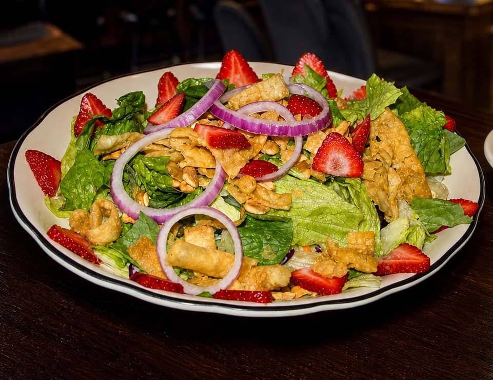 Enjoy Liberty’s Minnesota salad: lettuce, strawberries, red onions, nuts, and crispy wonton strips.